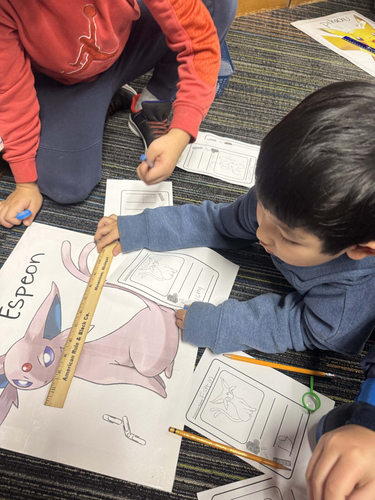 child measuring the pokemon Espeon