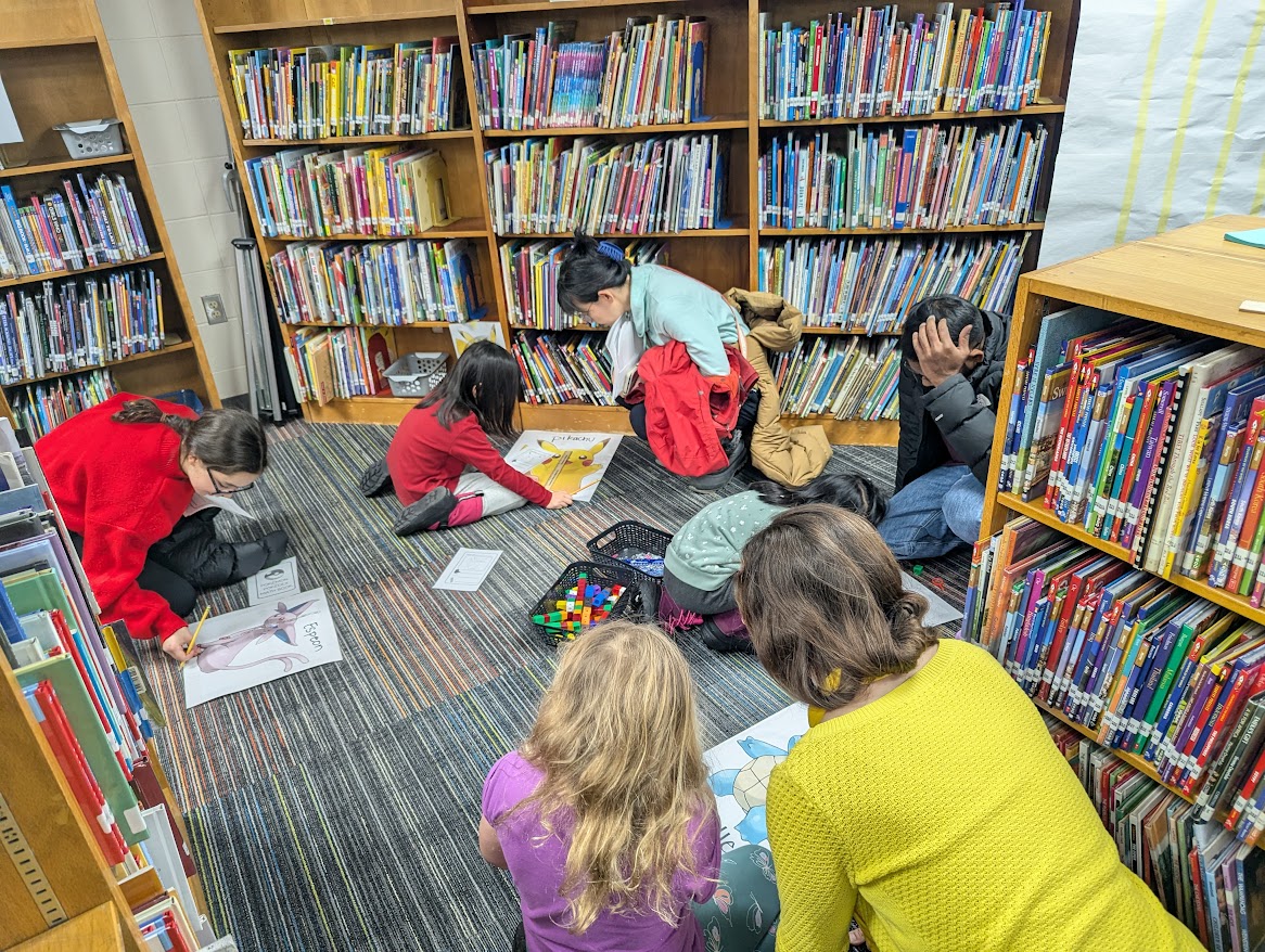 children and parents doing math in a library